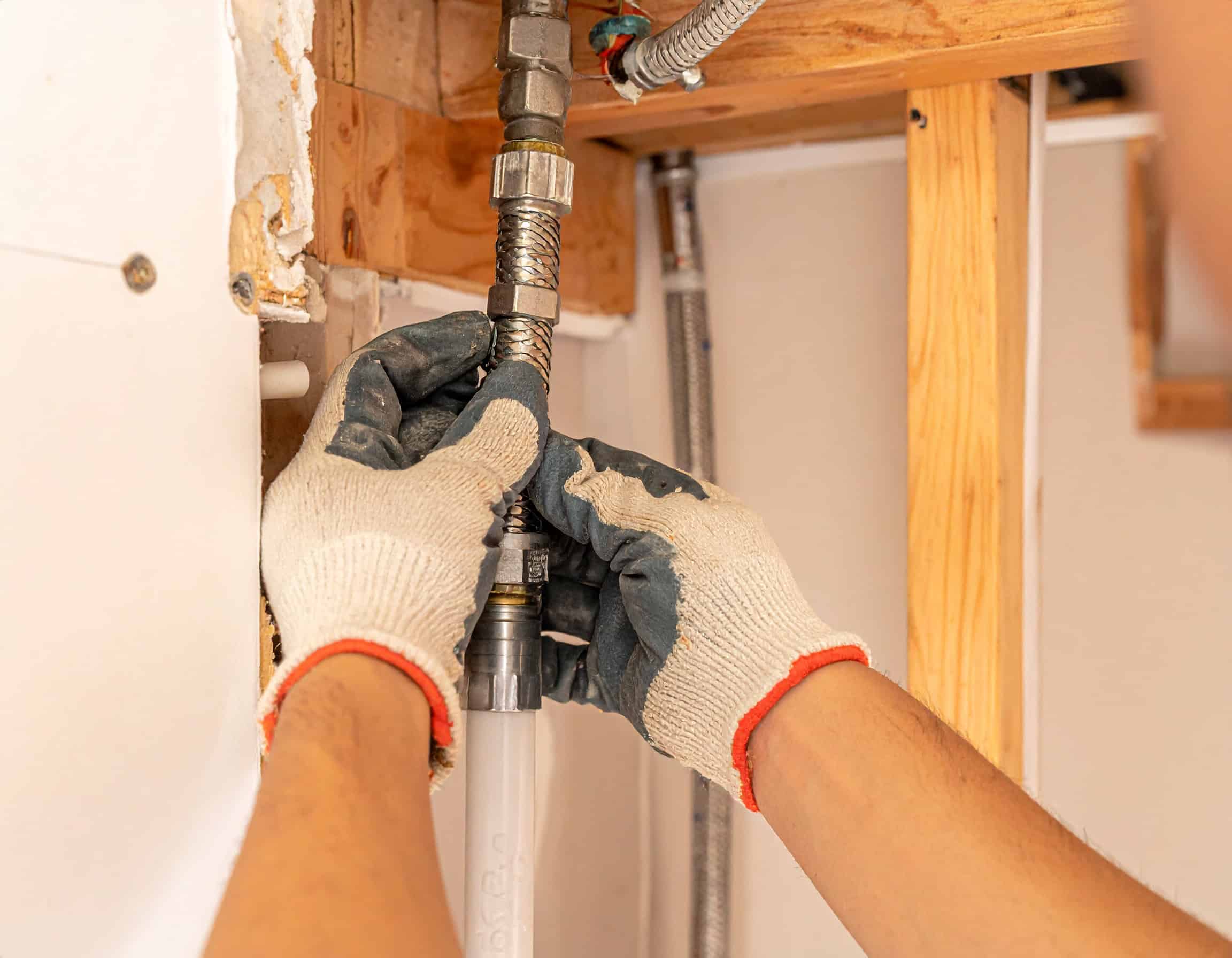Firefly_Close-up of a professional plumber's gloved hands installing new PEX water lines insi 295668 (2)