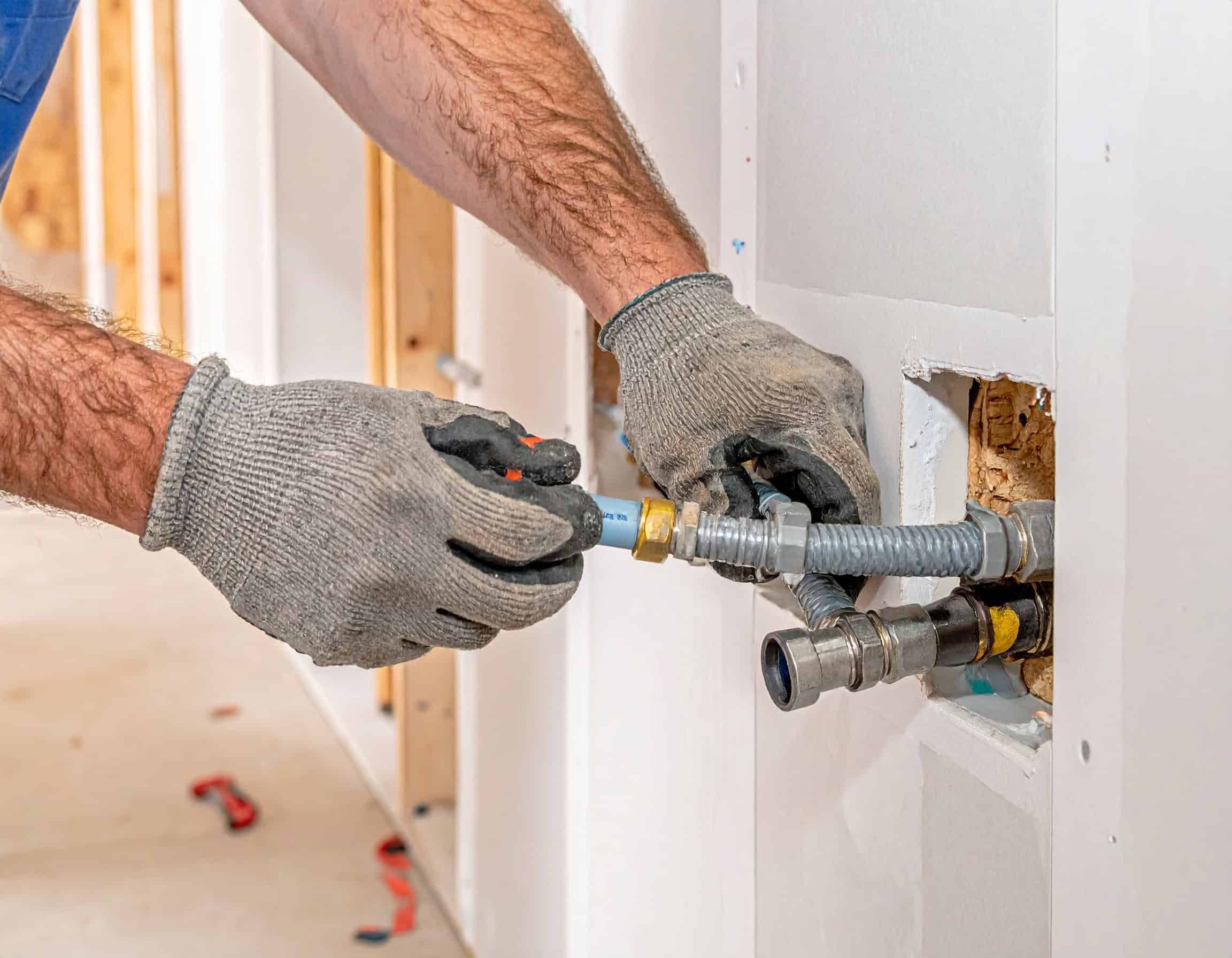 Firefly_Close-up of a professional plumber's gloved hands installing new PEX water lines insi 456326 (1)