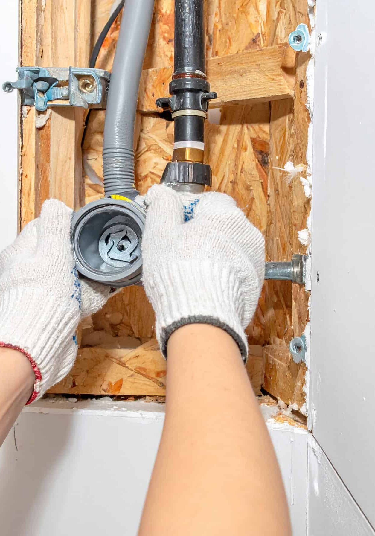Firefly_Close-up of a professional plumber's gloved hands installing new PEX water lines insi 644131 (1)