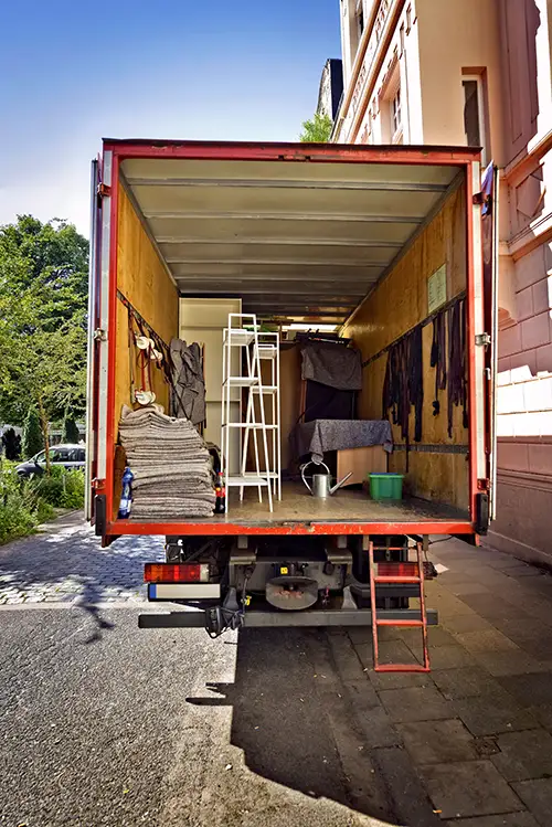 AdobeStock_147252538_Preview Photo of the back of a removal van, with doors open so you can see the belongings inside
