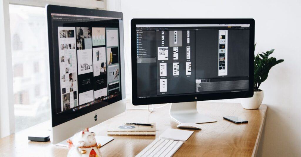 Dual computer screens showing website design layouts representing what makes a good website
