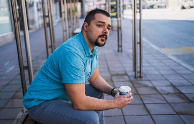 Man waiting in a bus stop