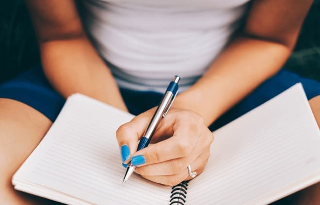 Woman writting in a notebook