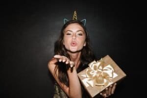 Beautiful happy young girl celebrating isolated