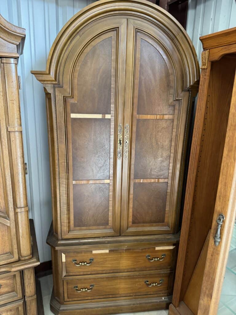 Elegant wooden display cabinet with glass doors and drawers for showcasing collectibles or fine chin.