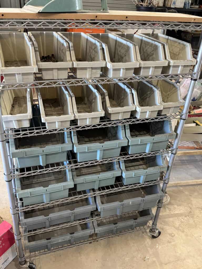 Storage shelving with plastic bins at Garrett Realty & Auction.