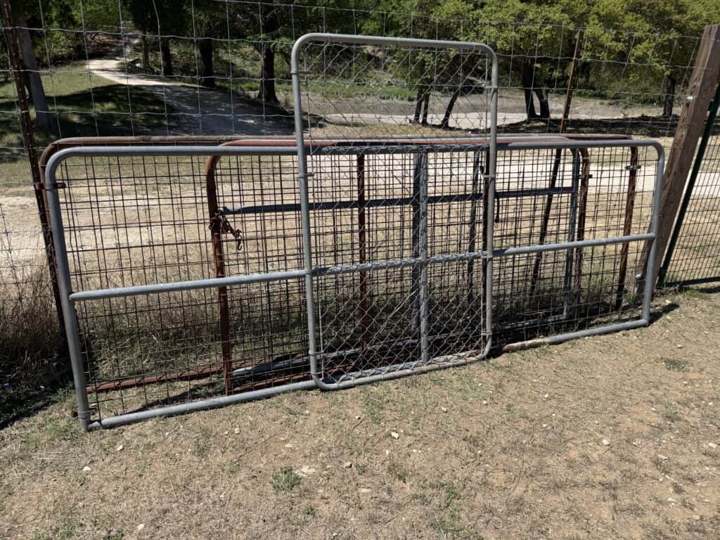 Metal fencing panels for sale at Garrett Realty & Auction.