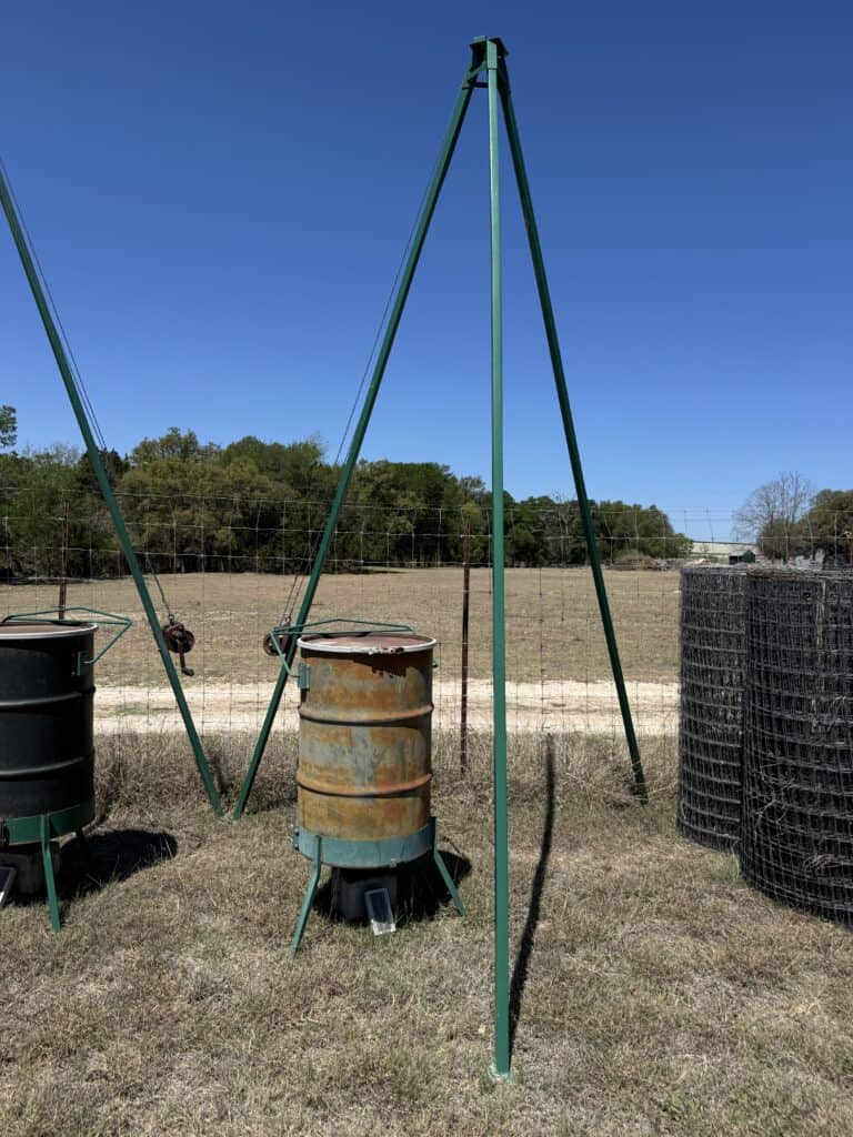 Outdoor fire pit with tripod stand and barrels at Mike Luckey Estate Auction.
