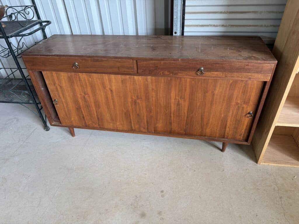 Mid-century modern wooden sideboard with drawers and cabinet storage.