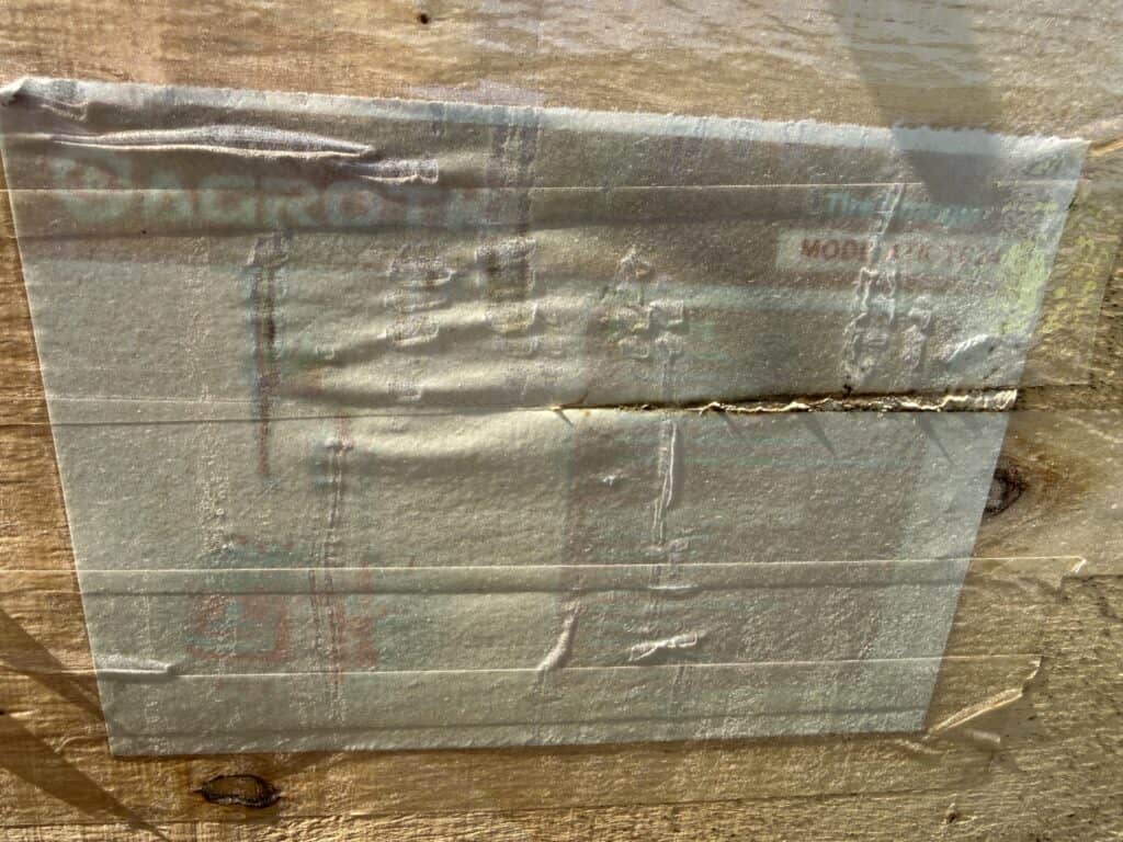 Auction equipment label on wooden surface at August 22nd auction.