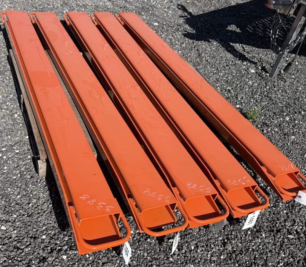 Bright orange safety barriers for equipment auction at Garrett Realty & Auction.