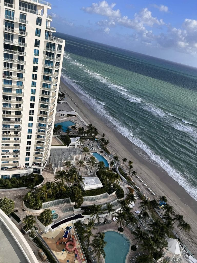 Beachfront hotel with ocean view and swimming pools.