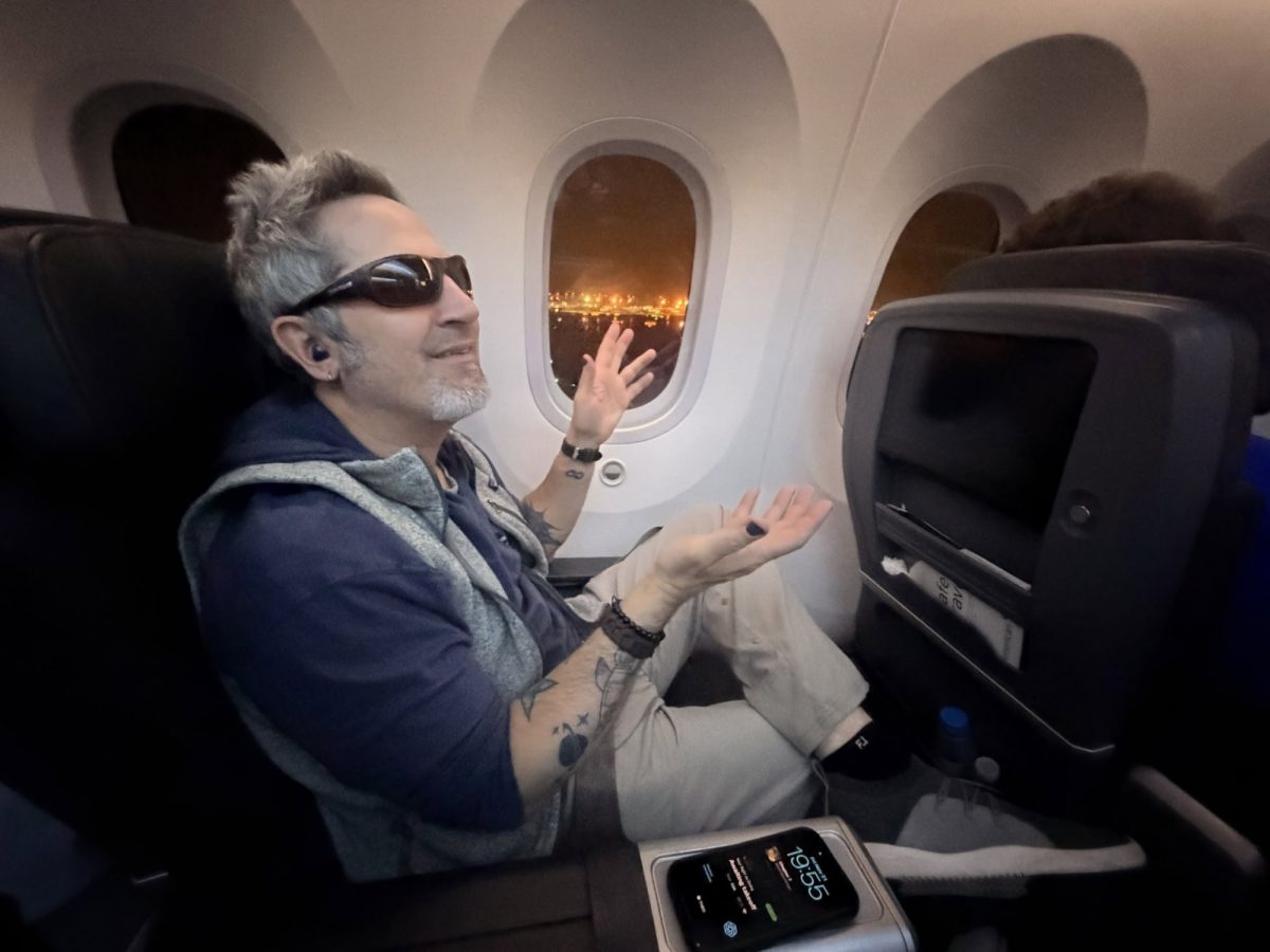 Luxury airplane travel with scenic night city views from the window.