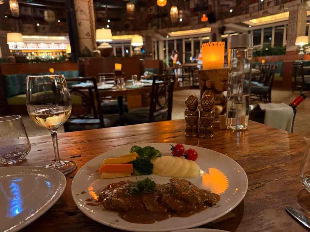 A delicious grilled steak served with broccoli, cherry tomatoes, and mashed potatoes in a cozy resta.