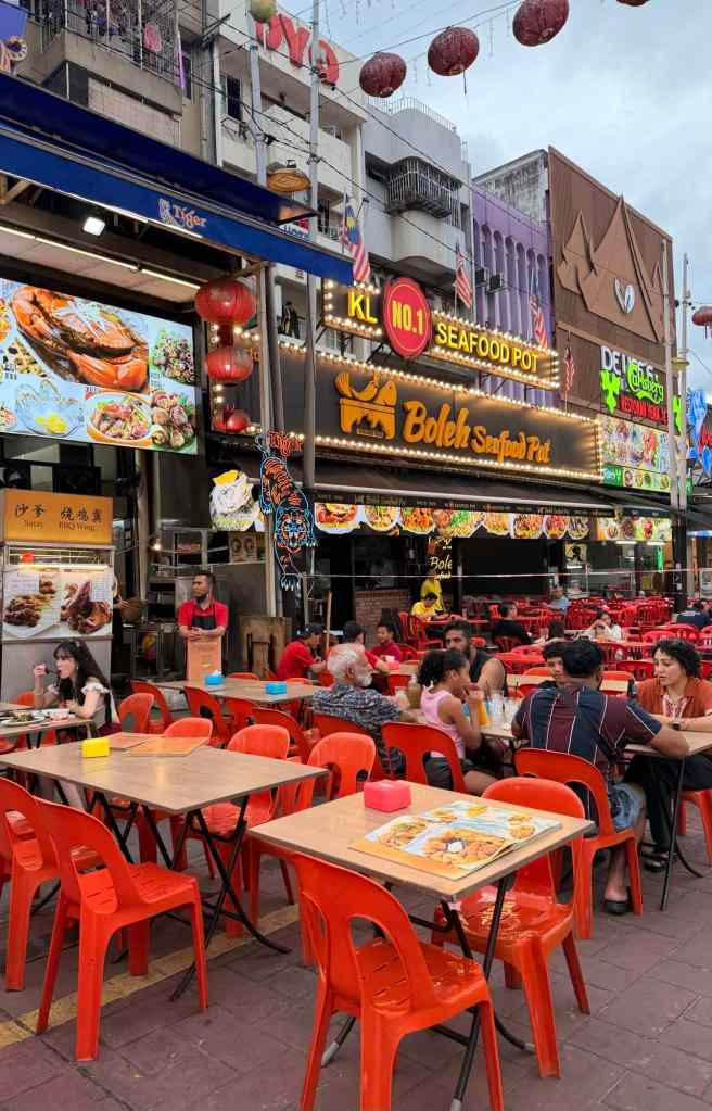 Seafood restaurant with outdoor seating and vibrant city backdrop in Kuala Lumpur, Malaysia.