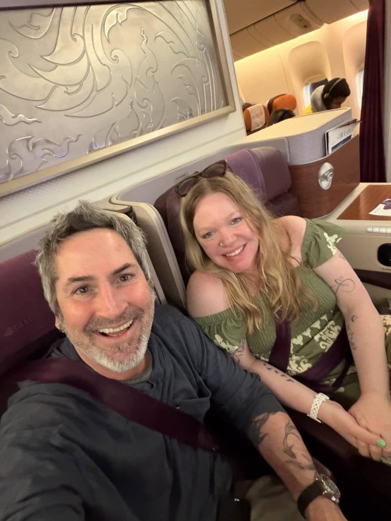 Traveling couple on an airplane enjoying their journey.