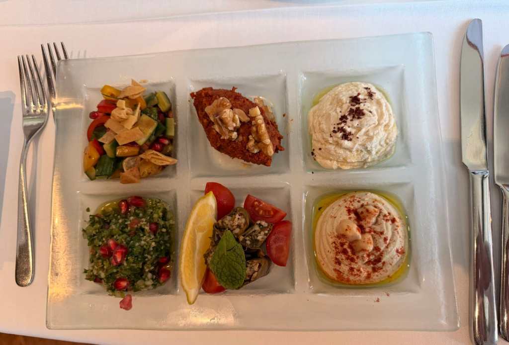 Elegant appetizer platter with six diverse dishes for a sophisticated dining experience.