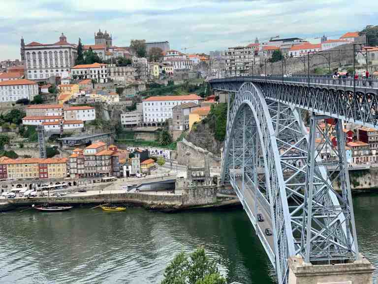 Lisbon cityscape with iconic 25 de Abril Bridge over the Tagus River.
