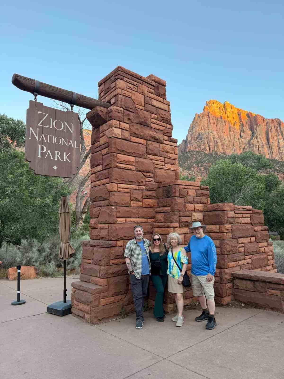 Family visiting Zion National Park with iconic red rock formations in the background.