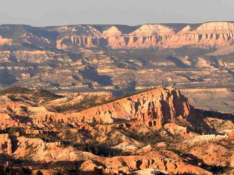 Grand Canyon sunset with colorful rock formations and expansive canyon views.