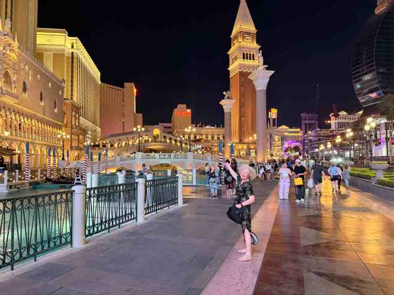 LiAnn and Theo exploring Las Vegas Strip at night with iconic landmarks.