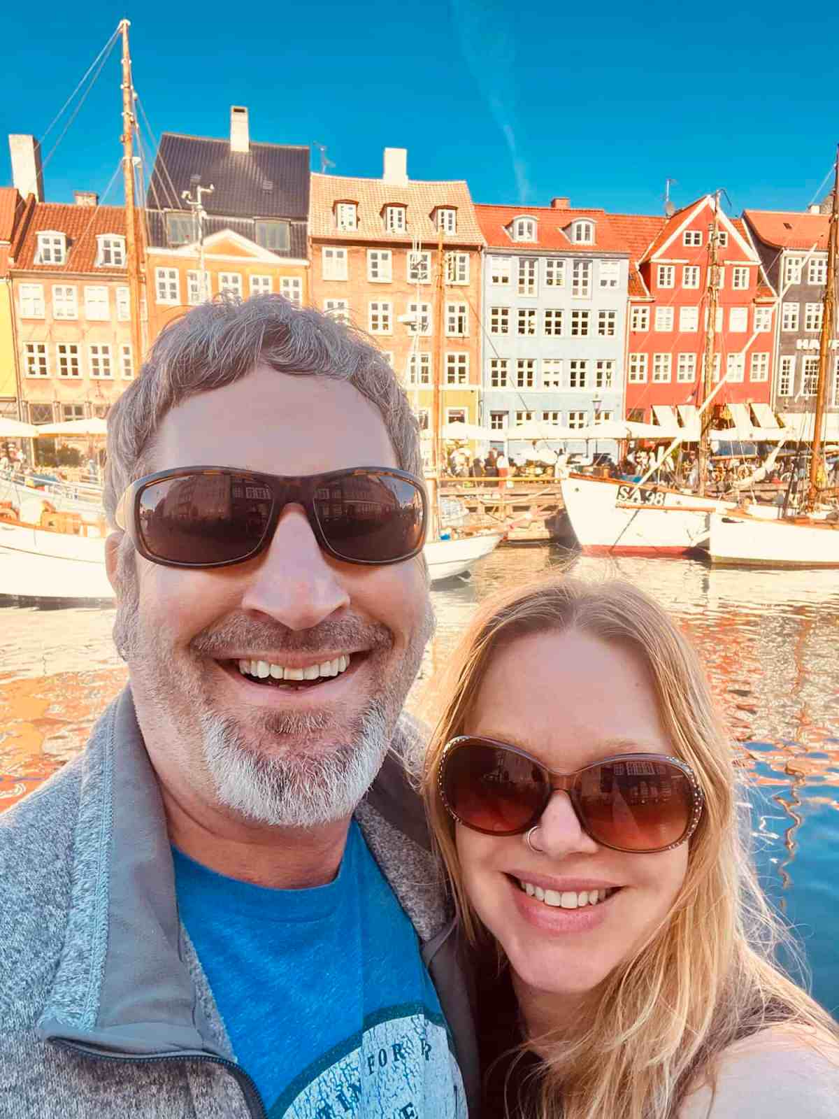 LiAnn and Theo wearing sunglasses at Nyhavn harbor in Copenhagen.