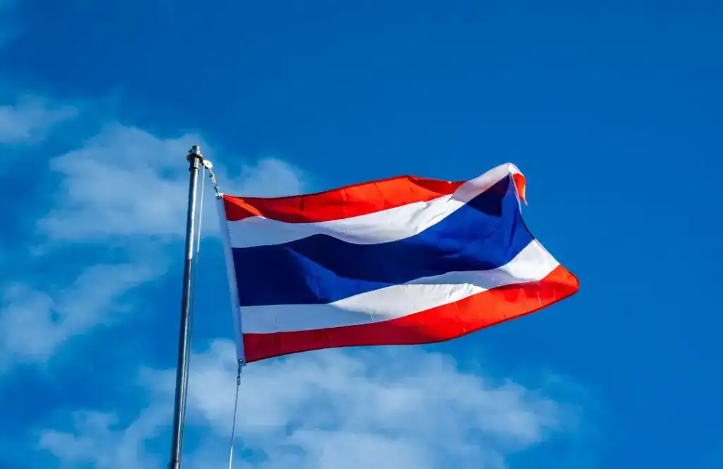 Thailand flag flying in the clear blue sky.