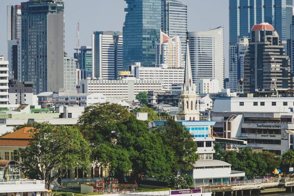 Bangkok city skyline reflected in the Chao Phraya River - Thailand property and real estate market for international buyers