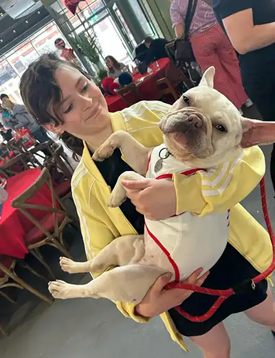 Girl carrying dog
