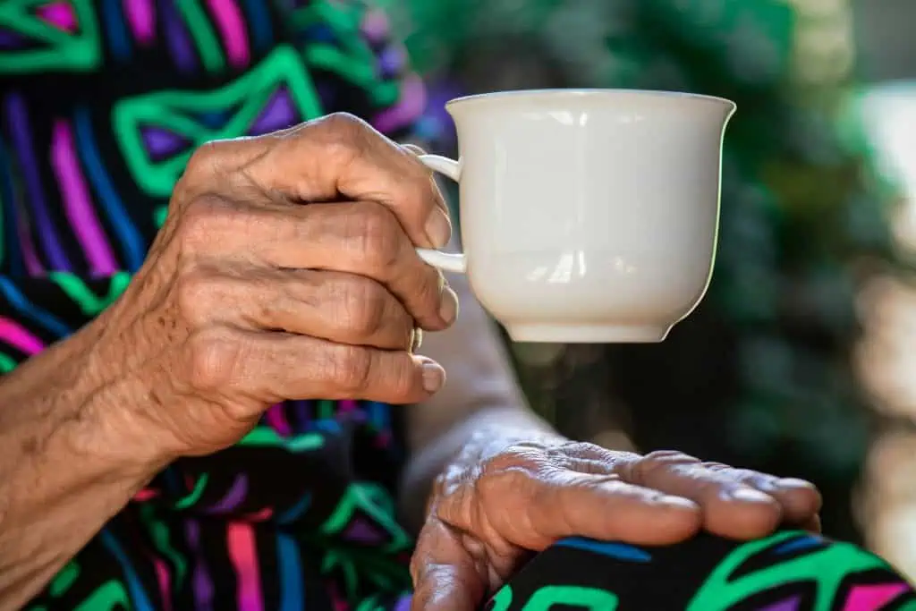 Senior citizen holding a teacup and receiving home care in Wheat Ridge, CO