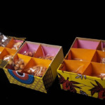 Colorful boxes of assorted chocolates and candies for sale.
