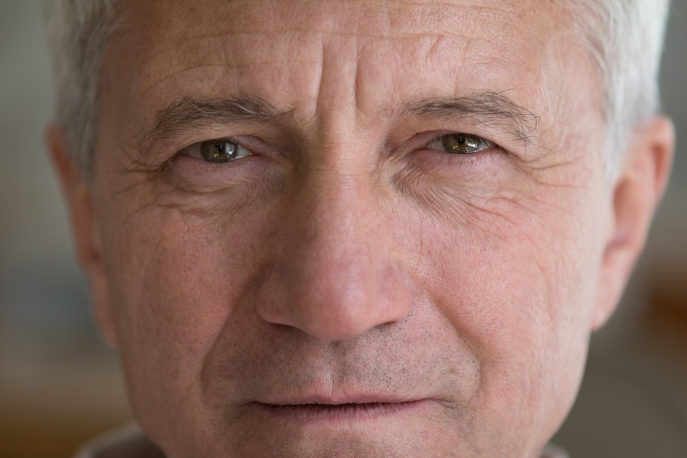 Older man with natural eyebrows looking into the camera.