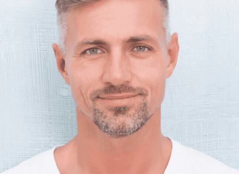 Close-up of a man with well-defined eyebrows after micropigmentation treatment.