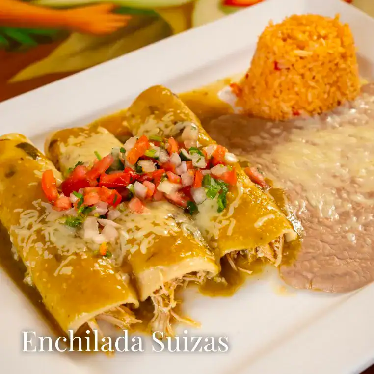 Delicious Mexican-style enchiladas topped with sauce, served with rice and beans. Perfect for a flav.