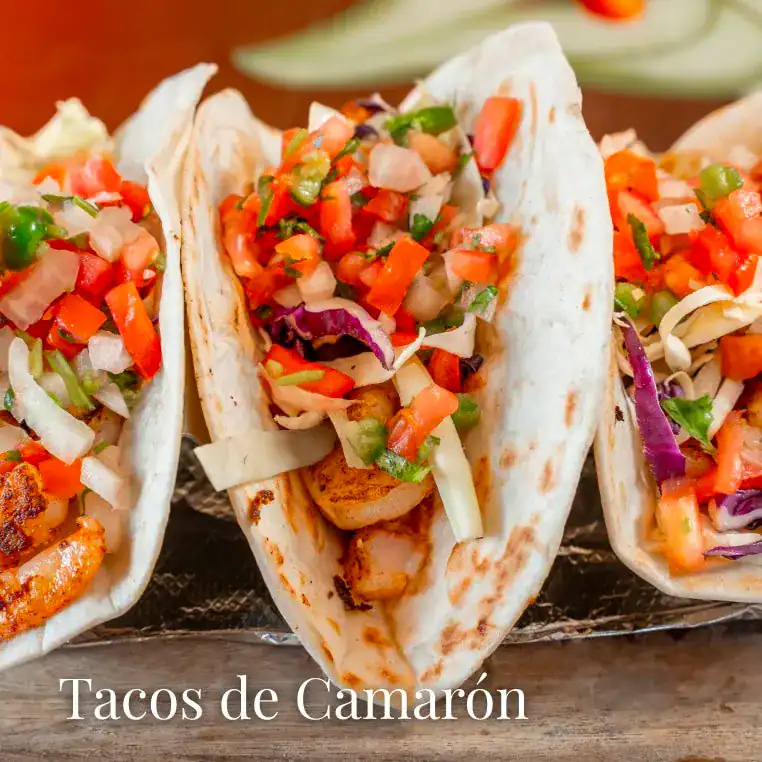 Shrimp tacos with colorful vegetable salsa, served on soft tortillas for a delicious seafood meal.