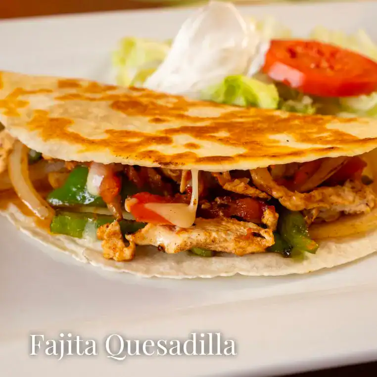 Tasty fajita quesadilla with grilled chicken, peppers, and cheese on a soft tortilla.
