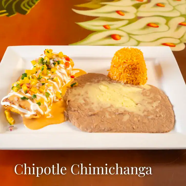 Delicious chipotle chimichanga served with rice and sauce.