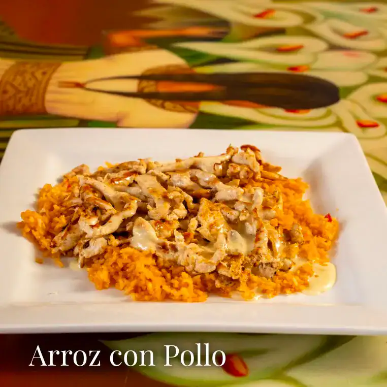Delicious arroz con pollo served on a white plate, showcasing a flavorful Spanish rice and chicken d.