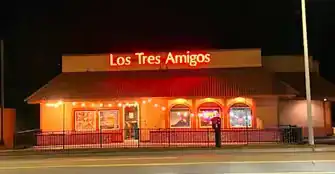 Night view of Los Tres Amigos restaurant with illuminated signage.