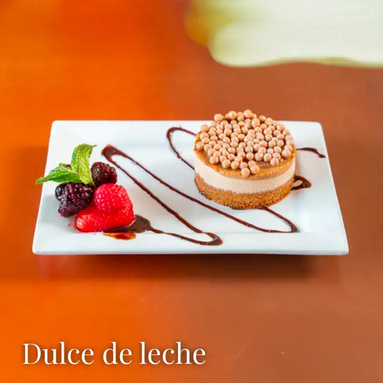 Delicious Dulce de leche cheesecake with chocolate and berries.