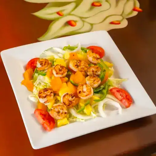 Fresh shrimp and colorful vegetables in a salad bowl.