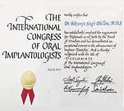 Certified dental implantologist holding international oral surgery award.