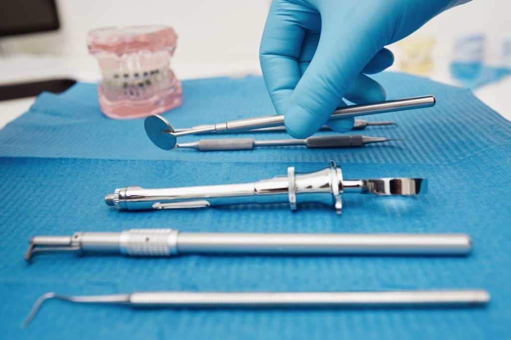 Dental instruments on a blue sterile cloth at Ludhiana Dental Centre for dentistry and oral care.