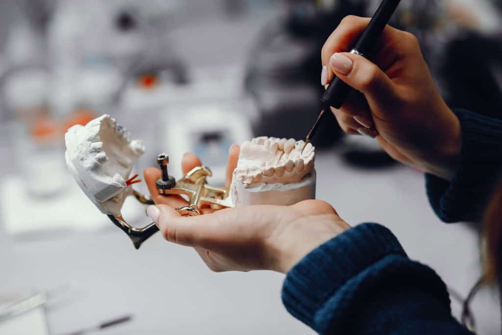 Dental technician working on a dental model at Ludhiana Dental Centre, expert in dental prosthetics and restorations.