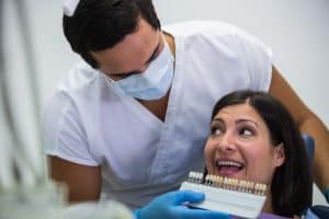 Dental professional examining teeth for dental care and cosmetic dentistry.