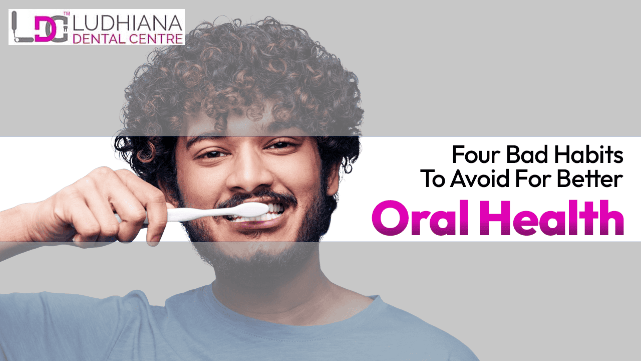 A man smiling while brushing his teeth