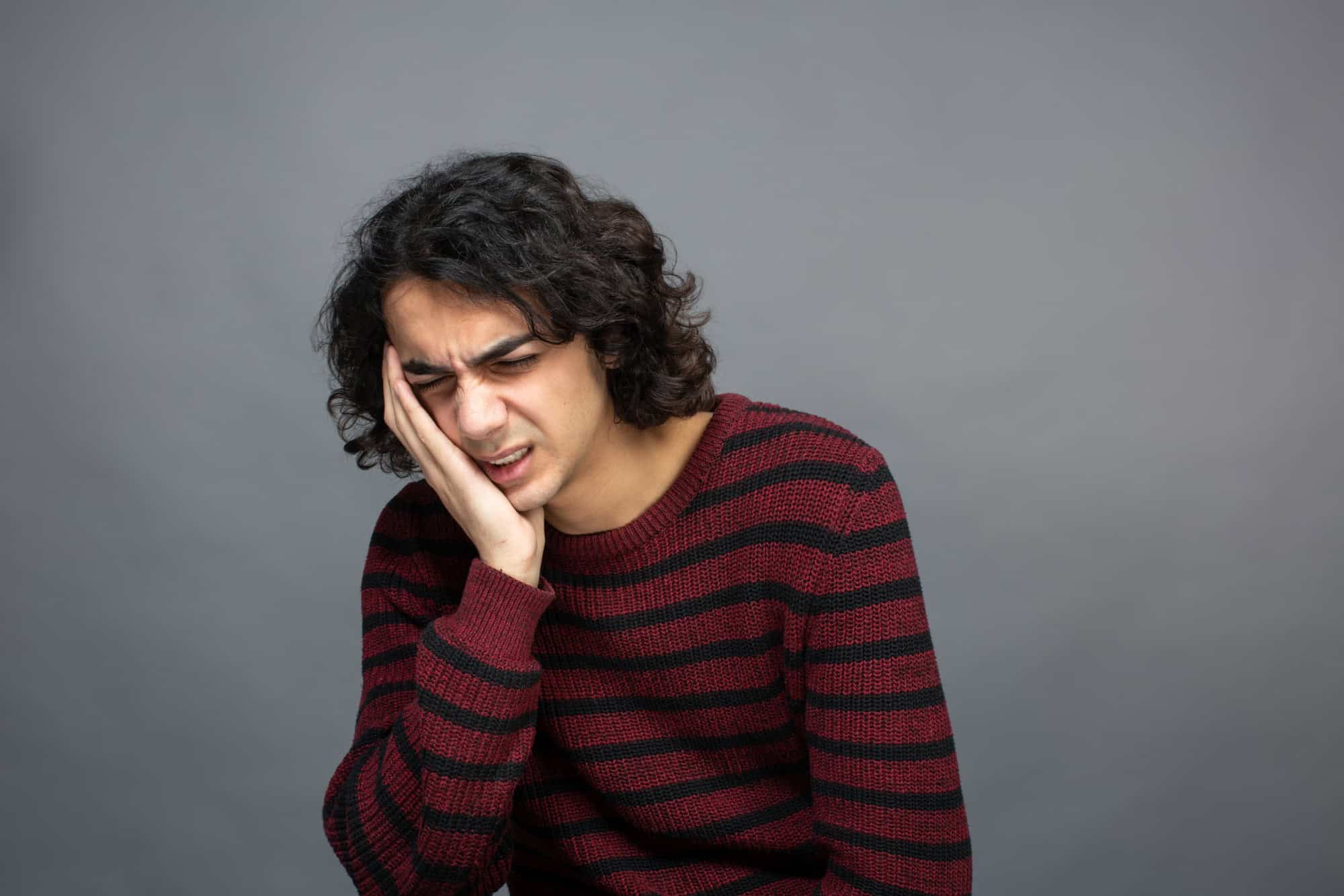 Tooth pain, dental discomfort, young man suffering with toothache, dental emergency, Ludhiana Dental Centre, oral health issue, dental clinic.