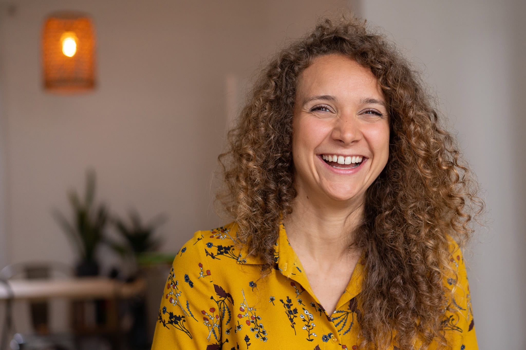 Lorraine Wilkes, a coach, radiates confidence in a warm, naturally lit London brand portrait.