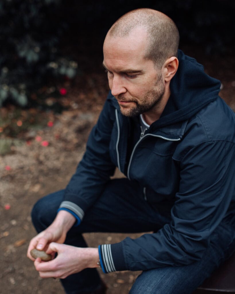Phil Askew, London brand photographer, captures a thoughtful coach portrait in natural light.