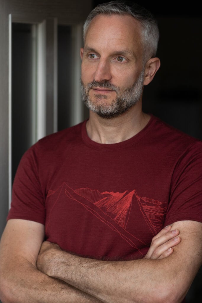 Andrew Willson, a London brand photographer's subject, with a confident, authentic presence, captured in soft light.